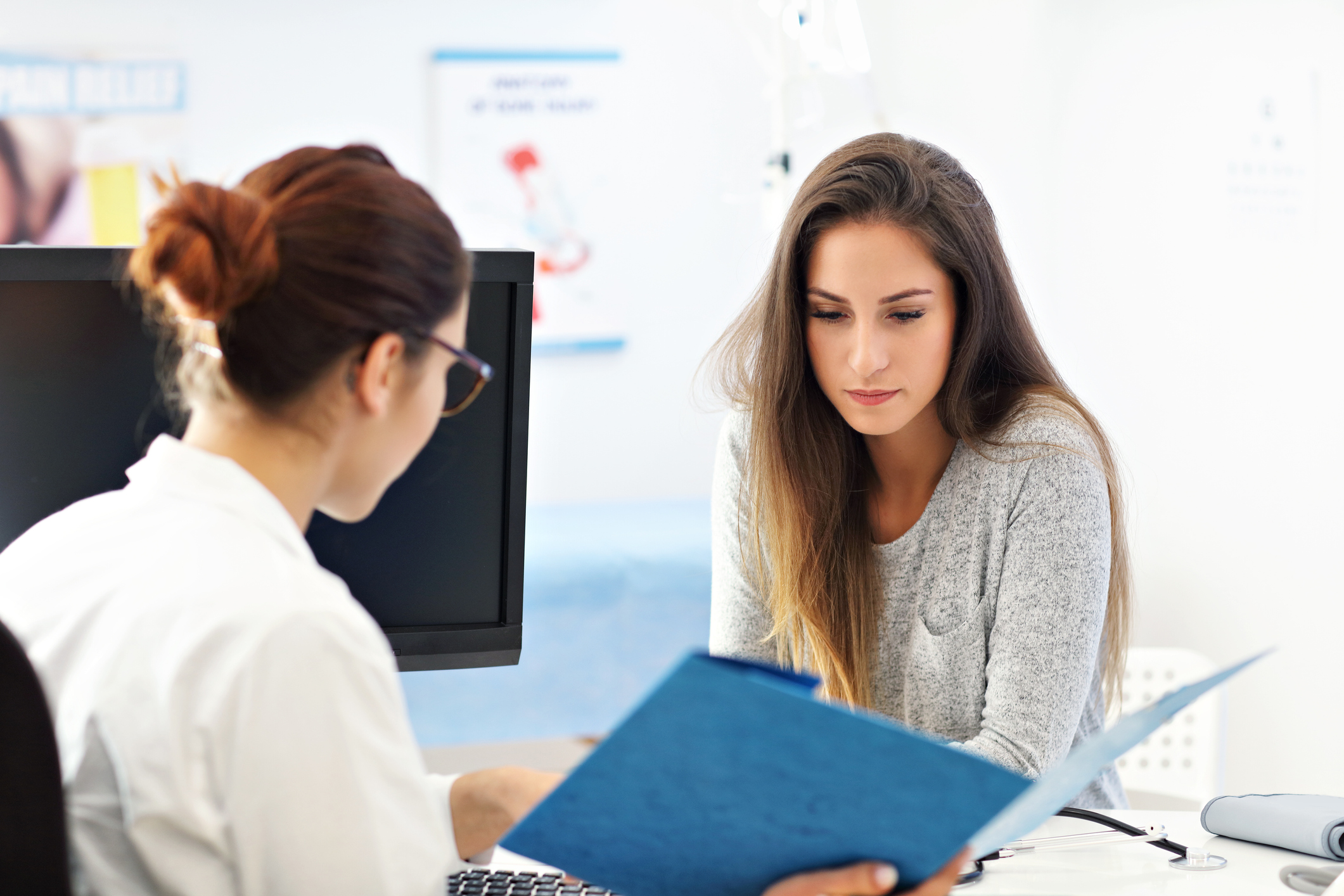 Picture of adult woman having a visit at female doctor's office